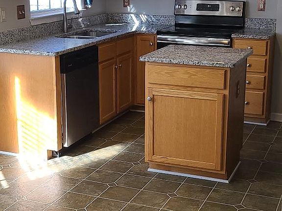 Full kitchen with granite and stainless appliances