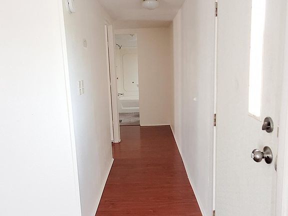 Hallway to other two rooms and bathroom