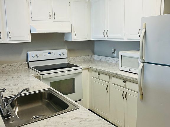 Kitchen with new counter tops and newly painted cabinets!