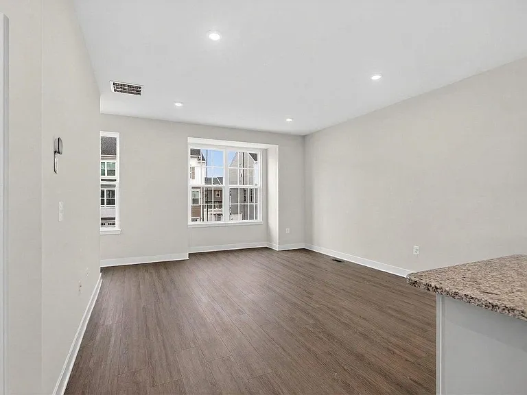 2nd floor living area with LVP, and an alcove overlooking the front of the house