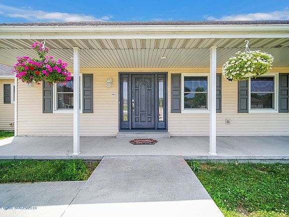Country living close to town. Expansive covered porch lines the front of the home. Porch is wired for fans or lights.