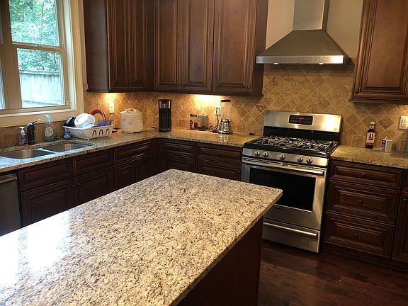 Spacious kitchen island and stove with vent