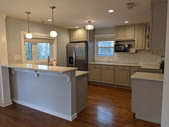 Open floor plan with updated kitchen and breakfast bar area.