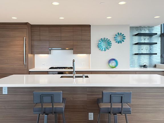 High end Bosch appliances in this open kitchen, gas cooking and bar area.