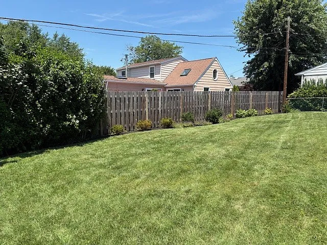 Backyard from left side of the house. Yard is 30 yards wide and completely fenced.
