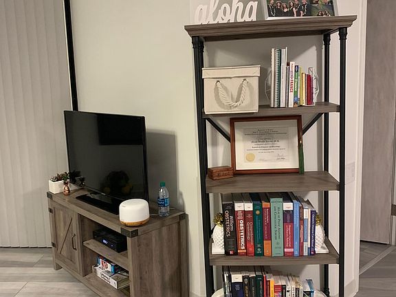 Furnished TV/TV stand and bookshelf.