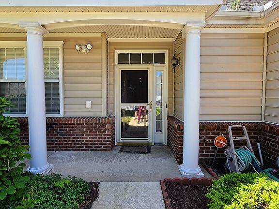 A covered, columned front porch welcomes your guests, complete with a security system setup for ultimate peace of mind.