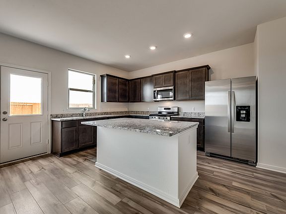 Enjoy stunning granite countertops and designer wood cabinetry in this kitchen.
