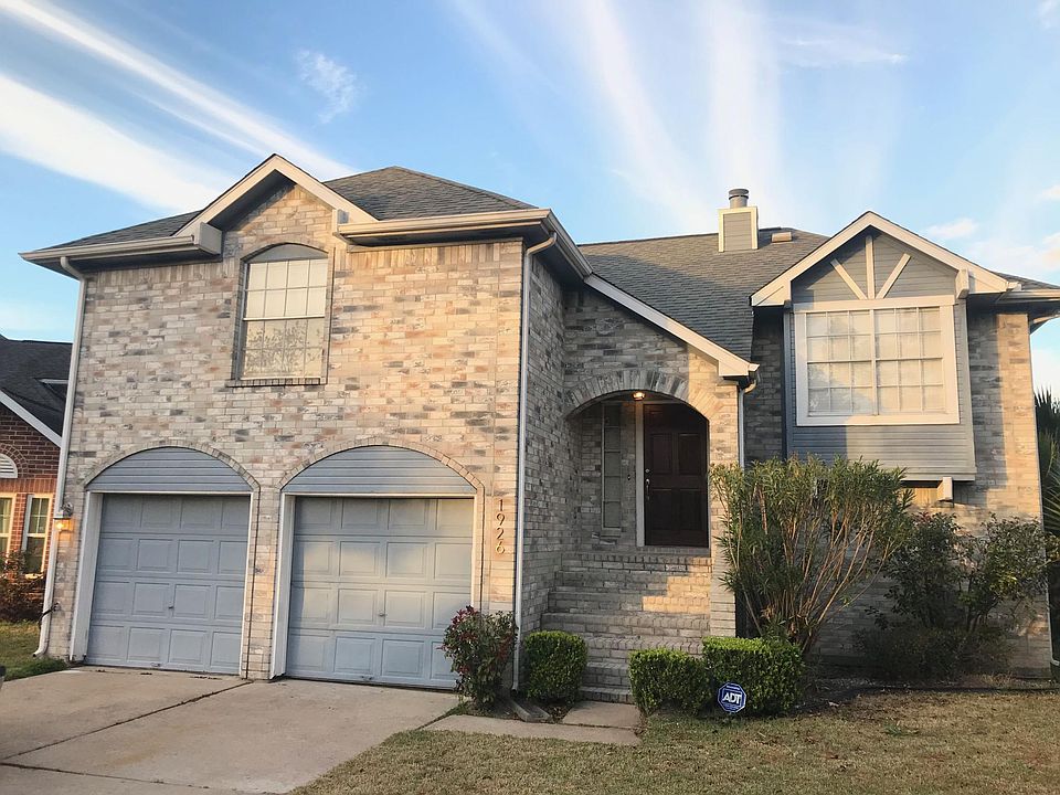Front house. Two car garage. The entry is a split level. Left window is master, right window is kitchen.