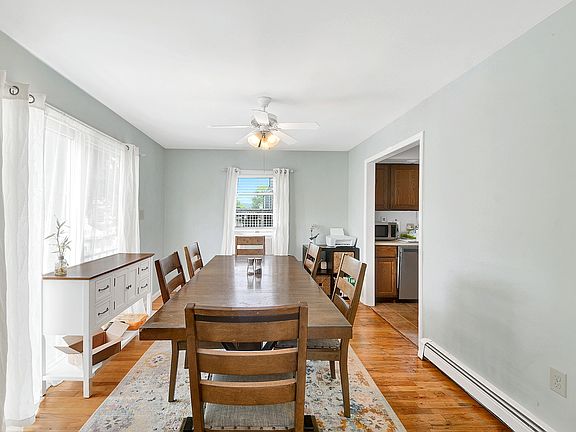 Separate dining room with double exposure, ceiling fan and hardwood floors