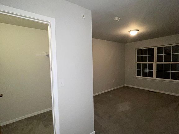 master bedroom with master bath and walk-in closet