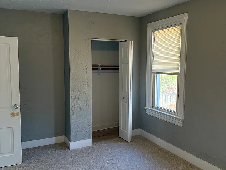 Bedroom 2 with closet build out, new carpet and fresh paint. Overlooks rear yard.