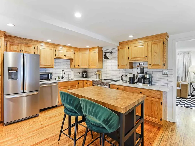 kitchen with stainless appliances, espresso/coffee maker, all cooking and serving items and 2 person bar