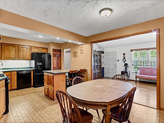 Spacious eat in kitchen features a pantry, tons of cabinet space, newer appliances, gas stove, under mount lighting, recessed lighting and backsplash.