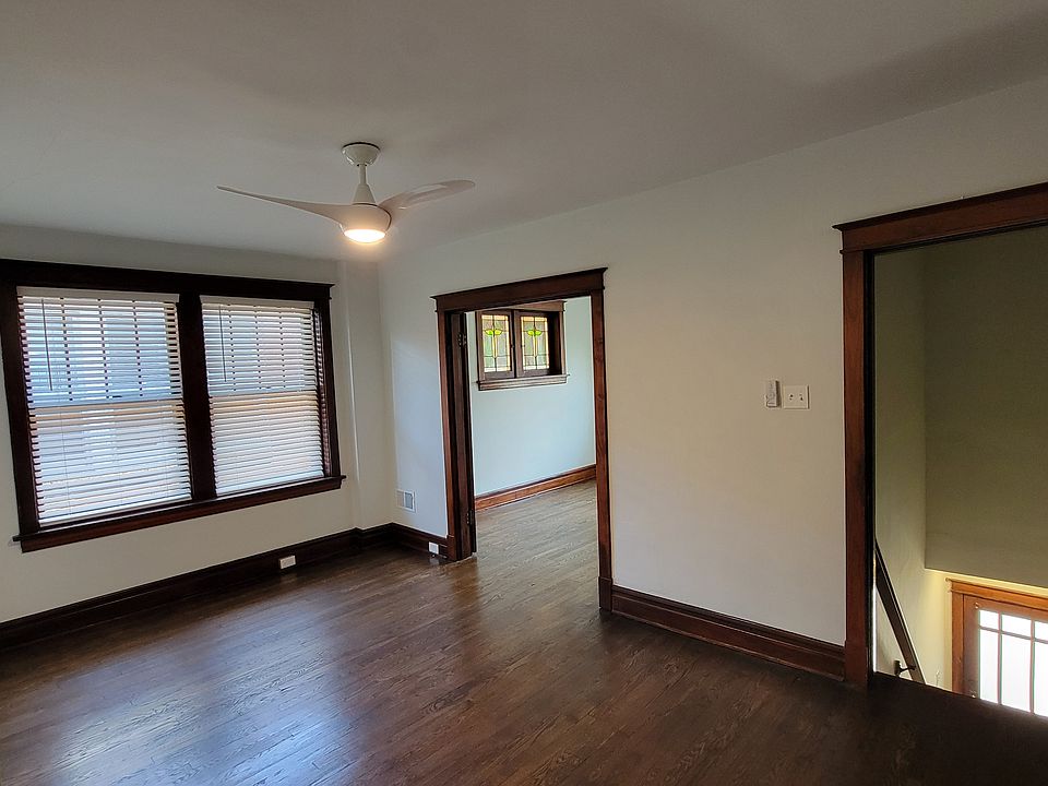 Living Area with view of private stairway entrance and opening to Bedroom 1 (French doors swung open on inside)