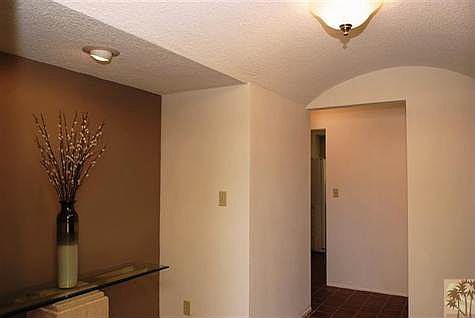 Formal entryway with original clay tile and arched entry ceiling.