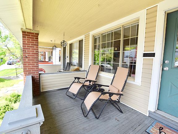 Front porch easily fits large lounge chairs or dining set and has been upgraded with new vinyl patio roofing and porch lights since this photo was taken.