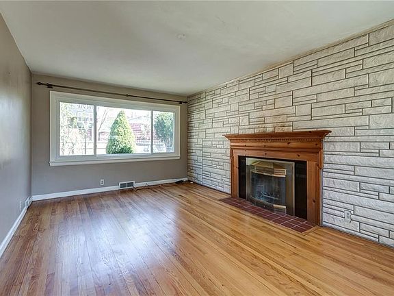 So much light enhances this Living Room. Wood Burning Fireplace for Delightful Ambience.
