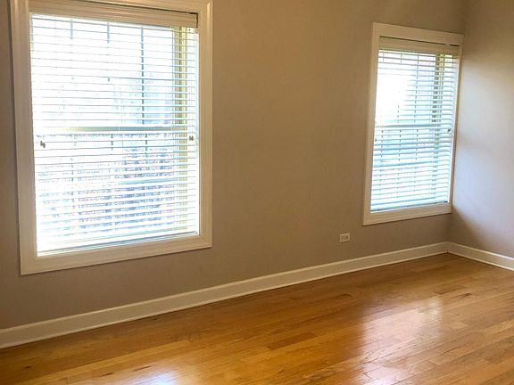Living room. Lots of light. Hardwood floors. New ceiling fan.