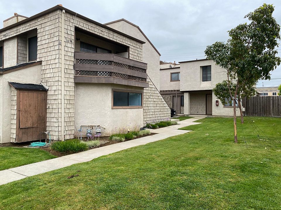 Right side of 4-unit property; grassy yard.