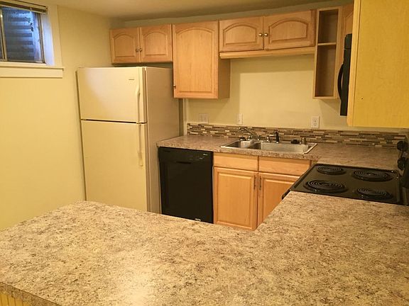 Newly remodeled kitchen features custom tile floors and backsplash.