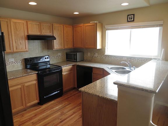Kitchen with Hardwood Floors, Double Sink, and Granite Count