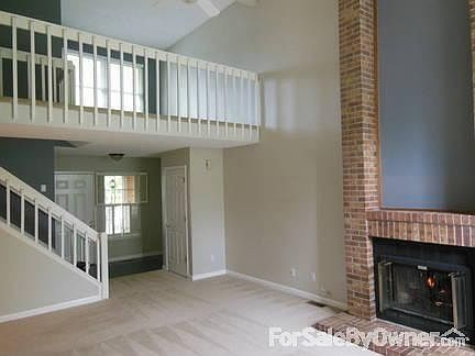 Entrance & Loft : View from back of living room showing fireplace, entry way, and loft