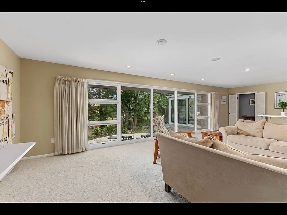 Back living room that looks out to mature trees and recently updated landscaping