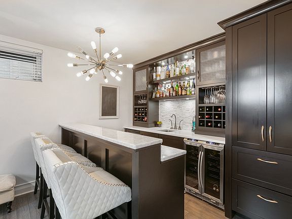 WET BAR WITH BEVERAGE AND WINE FRIDGE AND BUILT INS