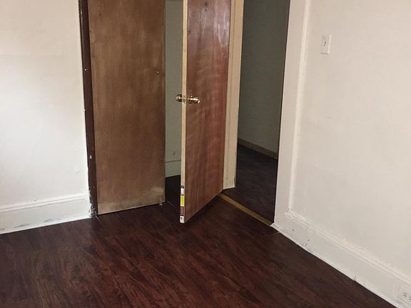 Bedroom with a closet and new flooring