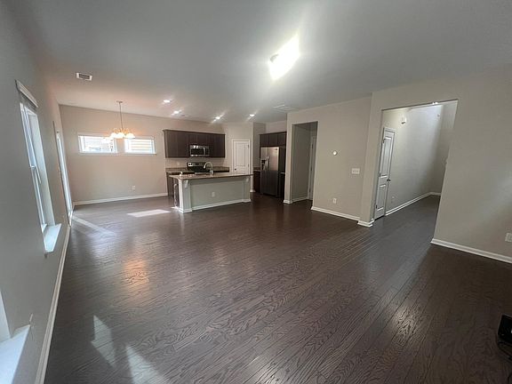 Open floor plan for kitchen and living room with island. You can make dinner while watching your children play.