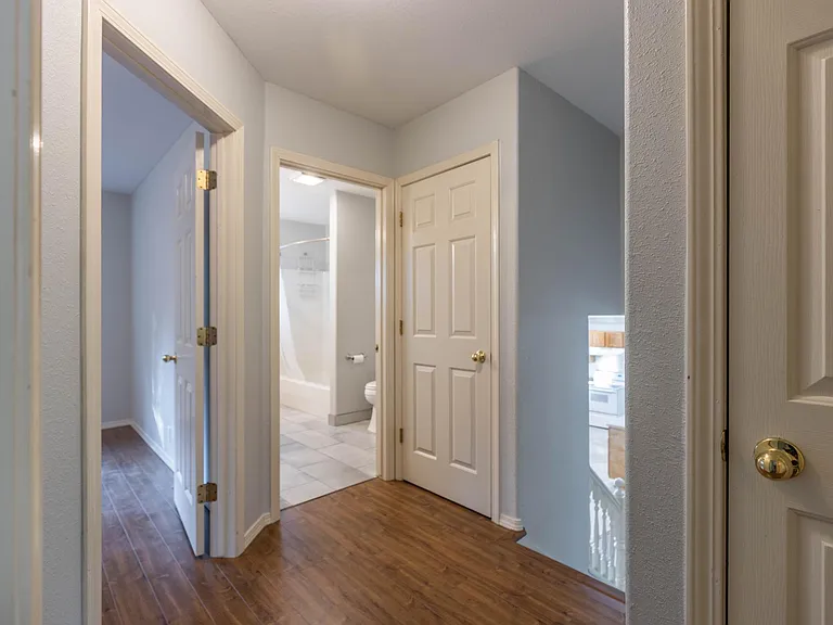 upstairs hallway that leads to three bedrooms, two hallway closets and upstairs bathroom