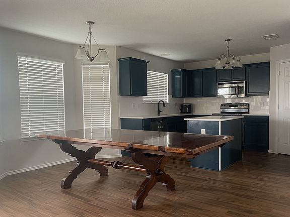 Kitchen & dining room. Pantry door pictured. Refrigerator included.