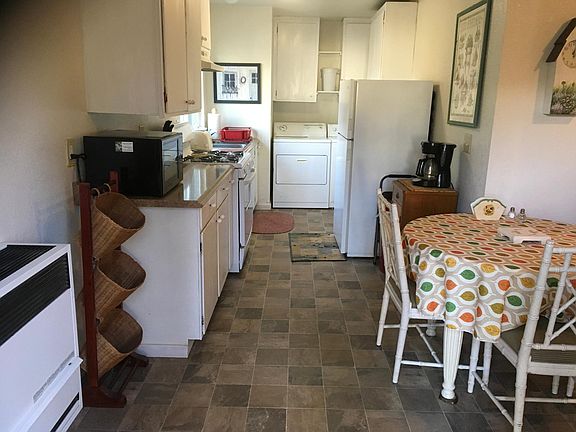 Full kitchen, with washer and dryer at the back portion of the kitchen.
