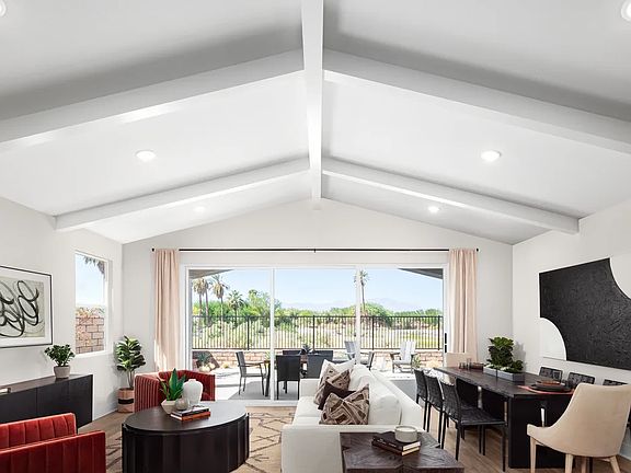 Great room with vaulted ceiling and white-painted ceiling beams