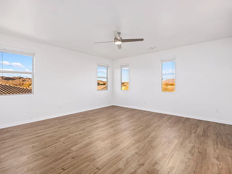 Large primary bedroom with mountain views out of each window. Large linen clost at entry