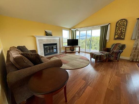 Living room with gas fireplace and deck looking out at Mount Diablo. The walls will be repainted a neutral color in January.