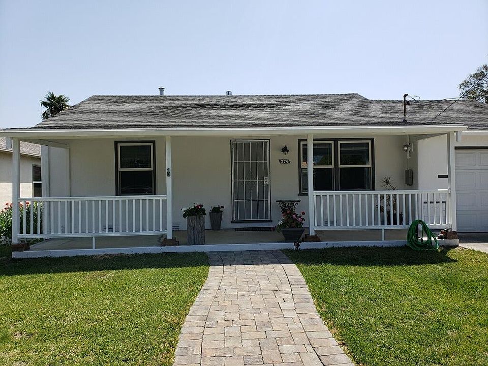 Front with covered porch and pavers