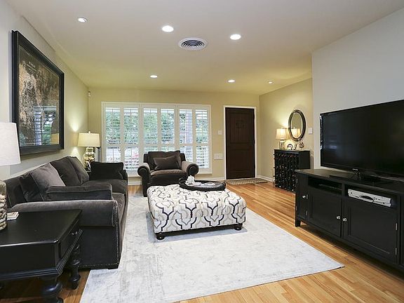 Living room (15x10) features plenty of natural light featuring custom wood plantation shutters, glea