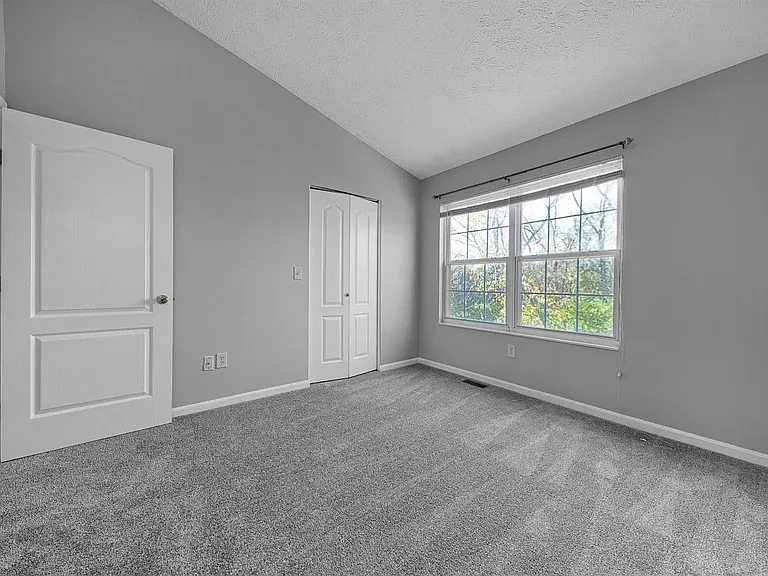 Back bedroom with vaulted ceiling - window view