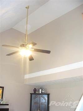 The living room has a vaulted ceiling.