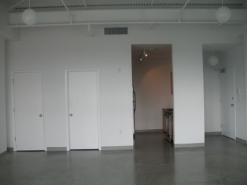 Entry is on right, kitchen, center door is bathroom, far left door is closet