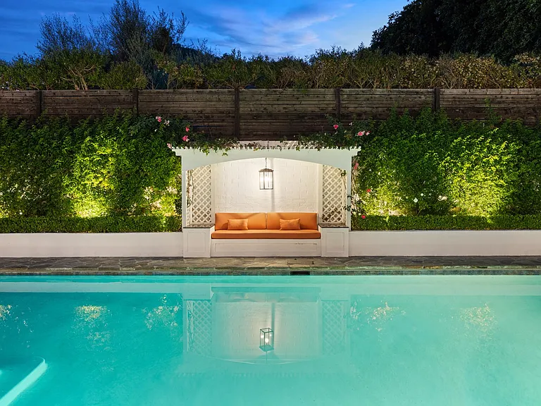 Enjoy the charm of an evening by the pool_an inviting feature that makes nights at home relaxing and delightful.