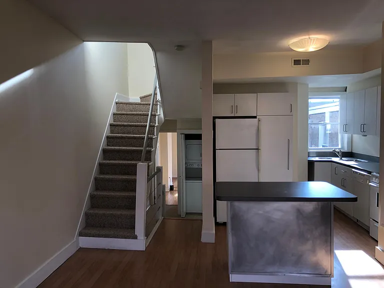 main living area; view from living room (shows hall closet that holds washer and dryer)