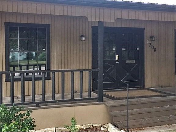 Front porch extending entire length of the home with double