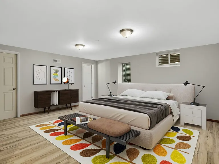 Virtually staged lower level bedroom illustrating additional sleeping space