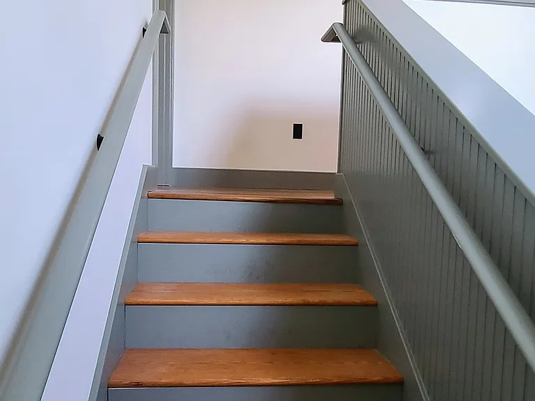 Interior stairs going up to apartment - airy, brand-new constructions, sprinklered building