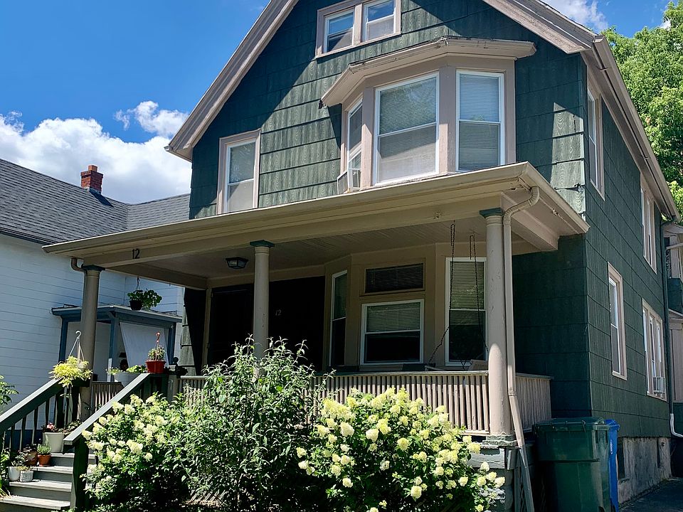 Front of the home. Features covered porch with hanging swing.