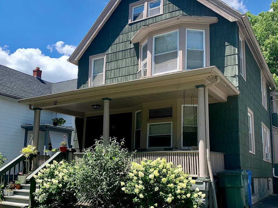 Front of the home. Features covered porch with hanging swing.