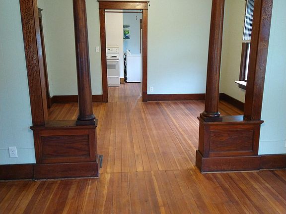 Standing in the front door, looking through the living room and dining room to the kitchen.